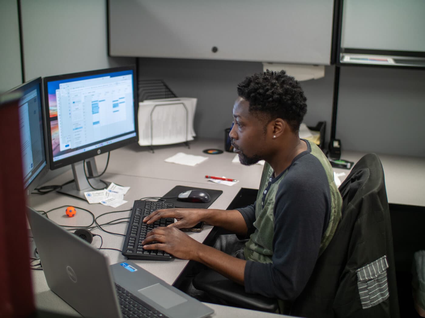 A Qualigence recruiter working a live search across multiple screens