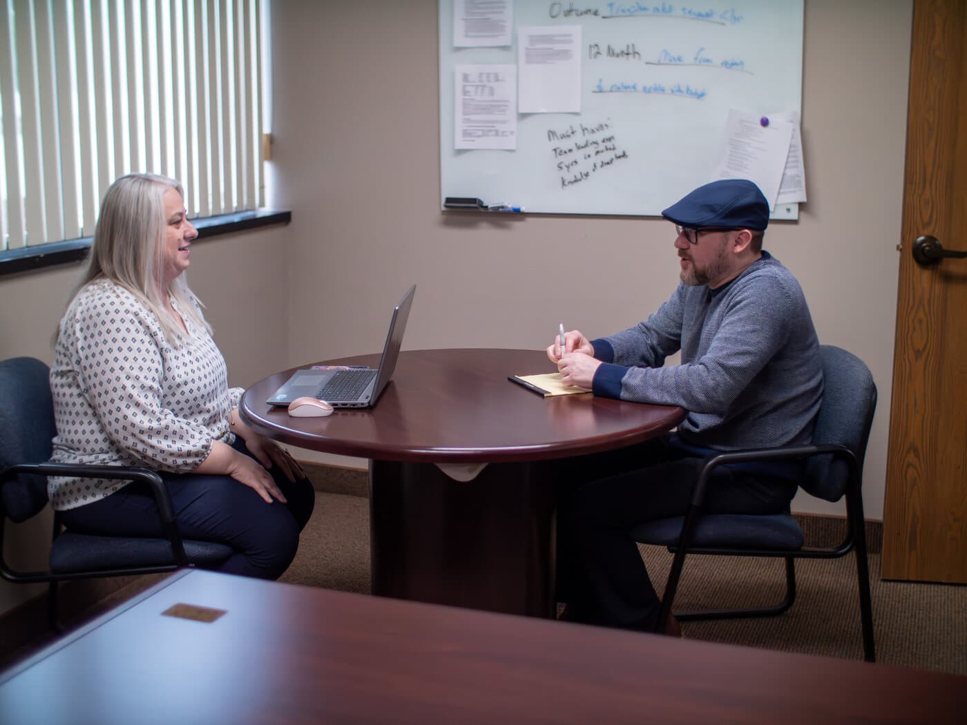 Qualigence researchers reviewing findings together at a shared screen